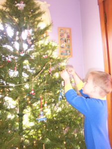 Payton hangs up an ornament.