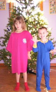 They pose for a picture in front of the finished tree. Yep, those are pink PLA pajamas.