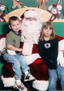 Emily refuses to smile with Santa. She also rebels by wearing a holloween witch shirt.