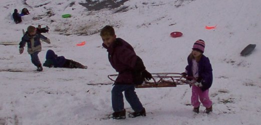 ryan and emily carry their sled back up the hill