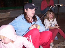 Jordyn, Tricia and Emily roasting marshmellows.